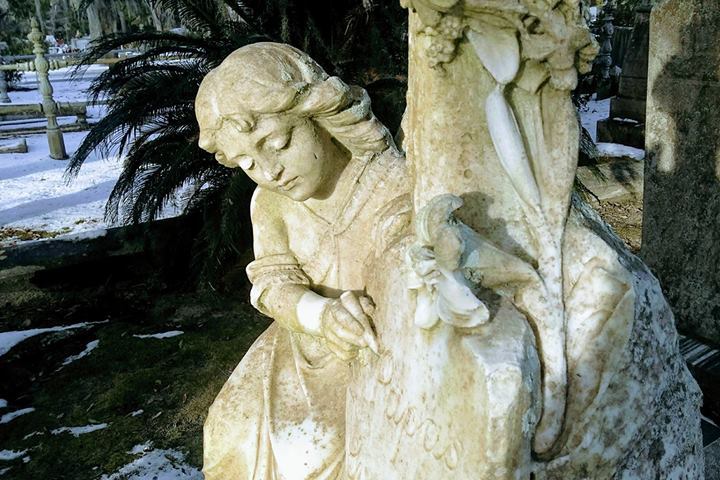 White statue of a girl carving