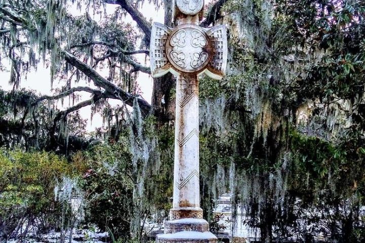 Tall white monument surrounded by trees